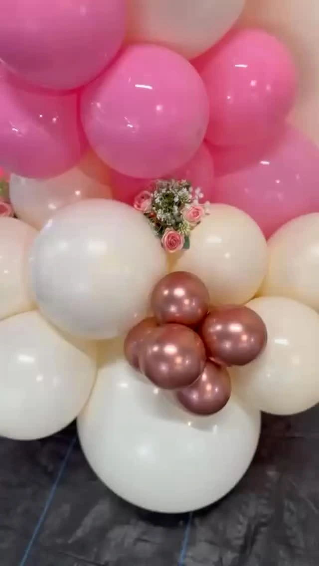 Close-up of pink, ivory and rose-gold balloon flowers from a personalized celebration.