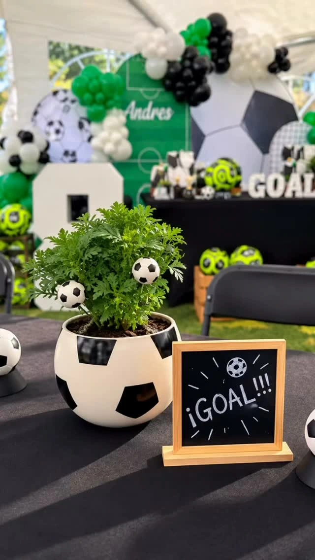 Personalized green and black soccer birthday décor with balloon details.